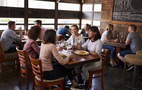 happy people at restaurant tables